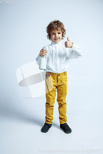 Image of Pretty young boy in casual clothes on white studio background