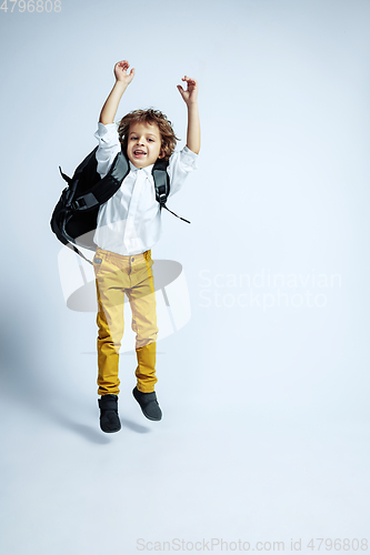 Image of Pretty young boy in casual clothes on white studio background