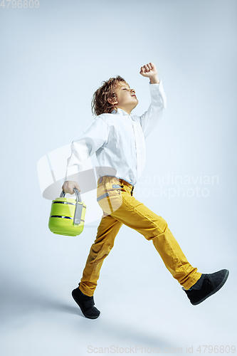 Image of Pretty young boy in casual clothes on white studio background