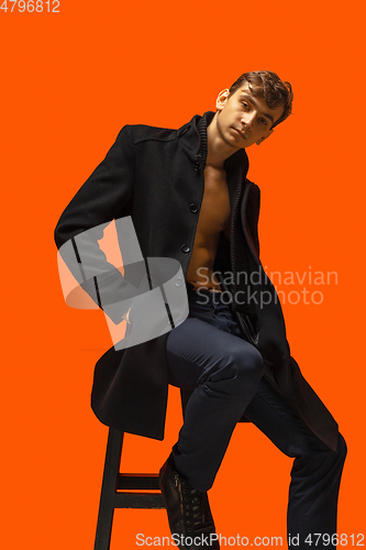 Image of Portrait of a handsome young man on orange background