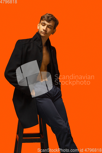 Image of Portrait of a handsome young man on orange background