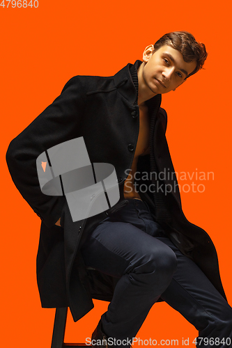 Image of Portrait of a handsome young man on orange background
