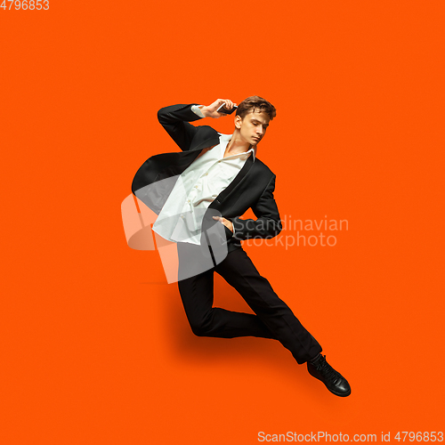 Image of Man in casual office style clothes jumping isolated on studio background