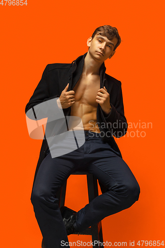 Image of Portrait of a handsome young man on orange background