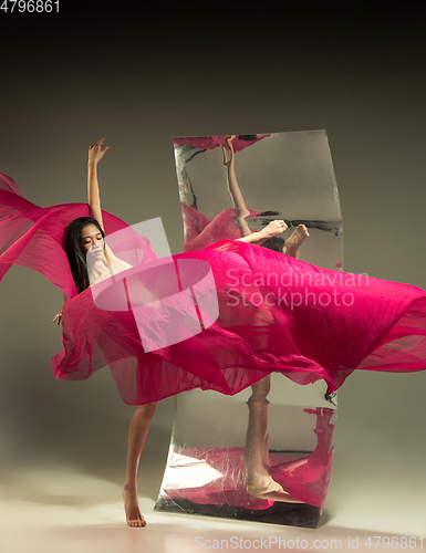 Image of Young and stylish modern ballet dancer on brown background