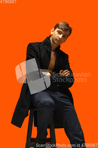 Image of Portrait of a handsome young man on orange background