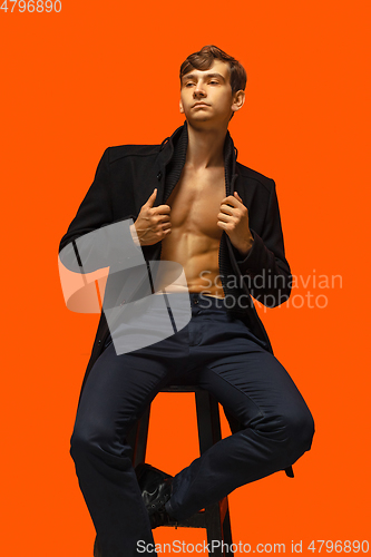 Image of Portrait of a handsome young man on orange background