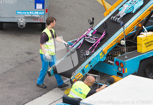 Image of AMSTERDAM, NETHERLANDS - JUNE 29, 2017: Loading luggage in airpl