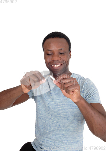 Image of Happy African man breaking a cigarette