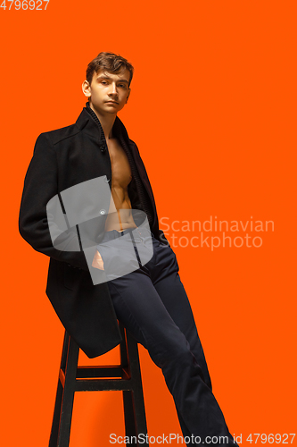 Image of Portrait of a handsome young man on orange background