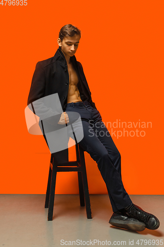 Image of Portrait of a handsome young man on orange background