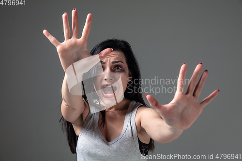 Image of Woman in fear of domestic abuse and violence, concept of female rights