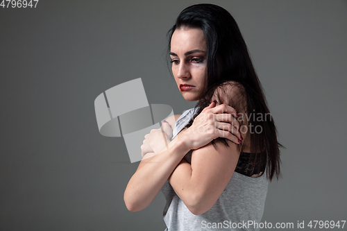 Image of Woman in fear of domestic abuse and violence, concept of female rights