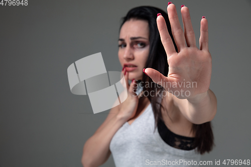 Image of Woman in fear of domestic abuse and violence, concept of female rights