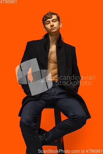 Image of Portrait of a handsome young man on orange background