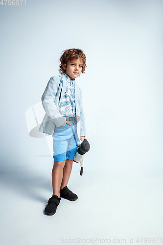 Image of Pretty young boy in casual clothes on white studio background