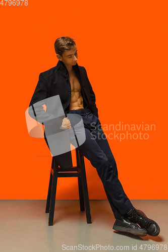 Image of Portrait of a handsome young man on orange background