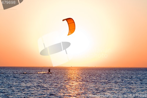 Image of Silhouette of a kitesurfer on a gulf on a sunset