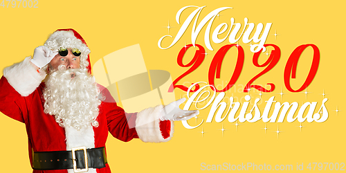 Image of Santa Claus isolated on yellow studio background