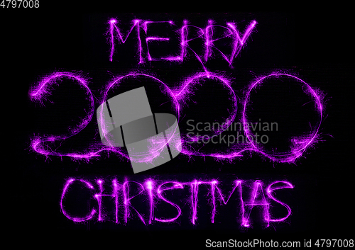 Image of 2020 in neon multi colour, parallel lines pattern on black background