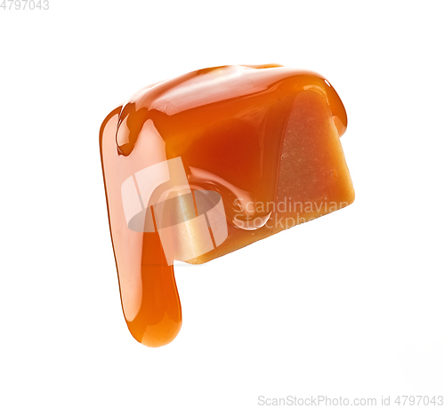 Image of caramel sauce flowing on flying caramel candy