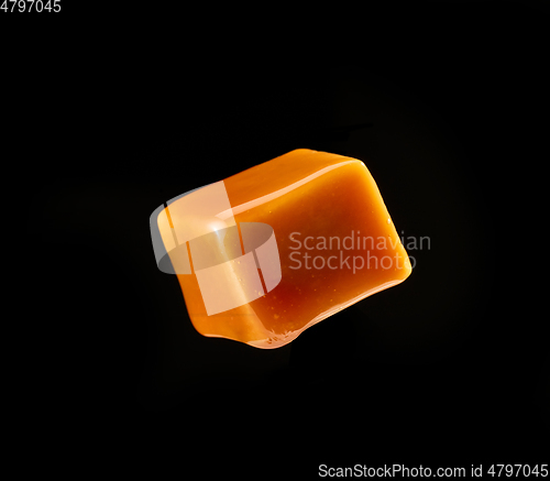 Image of caramel candy on black background