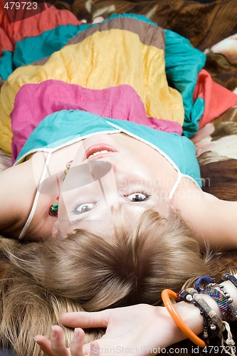 Image of The young beautiful woman lies on a bed