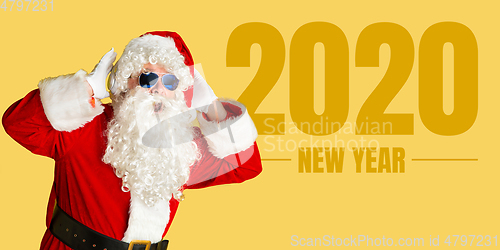 Image of Santa Claus isolated on yellow studio background