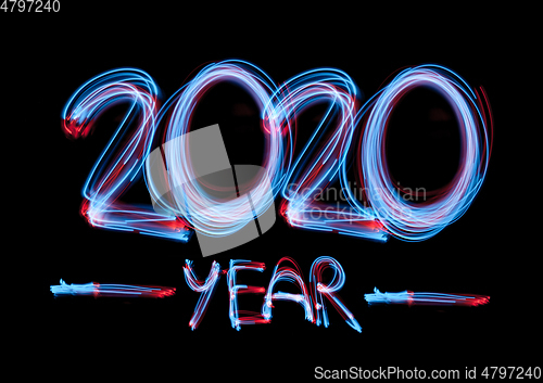 Image of 2020 in neon multi colour, parallel lines pattern on black background