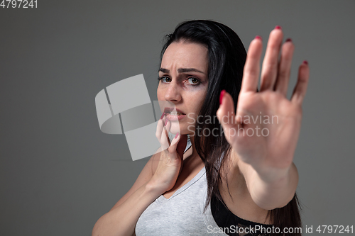 Image of Woman in fear of domestic abuse and violence, concept of female rights