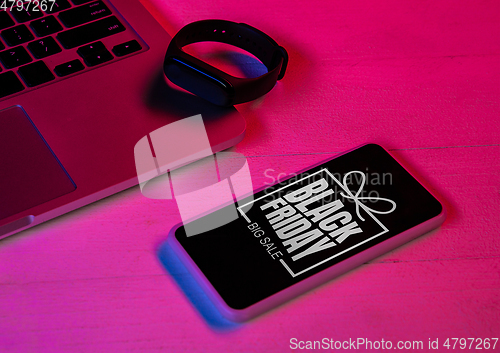 Image of Top view of set of gadgets in purple neon light