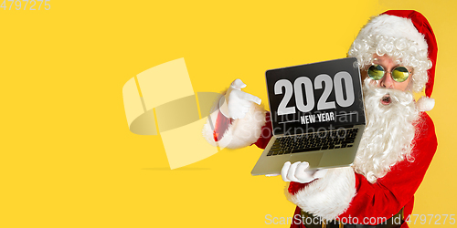 Image of Santa Claus isolated on yellow studio background