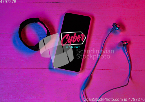 Image of Top view of set of gadgets in purple neon light