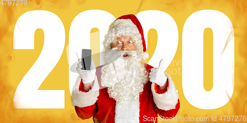 Image of Santa Claus isolated on yellow studio background