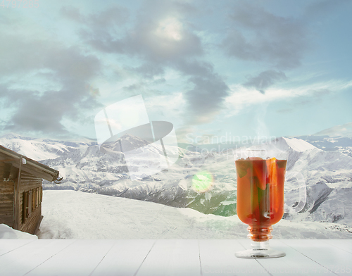 Image of Mulled wine and landscape of mountains on background