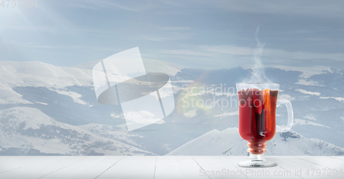 Image of Mulled wine and landscape of mountains on background