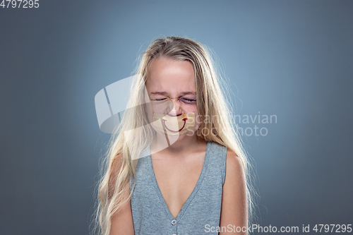 Image of Sad and frightened little girl with bloodshot and bruised eyes, fiction of happiness