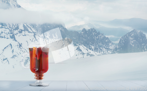 Image of Mulled wine and landscape of mountains on background