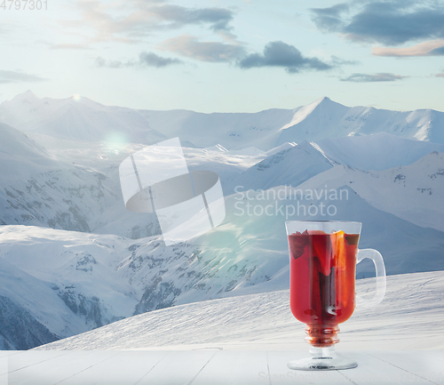 Image of Mulled wine and landscape of mountains on background