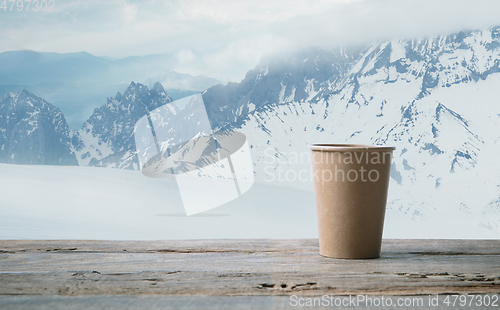 Image of Single tea or coffee mug and landscape of mountains on background