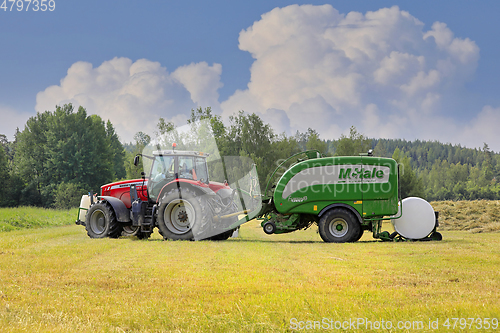 Image of Tractor and Baler in Hay Field 