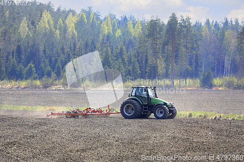 Image of Deutz-Fahr Tractor and Harrow in Field