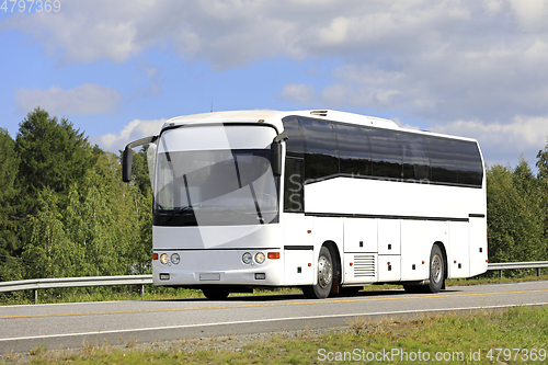 Image of White Bus on Summer Highway