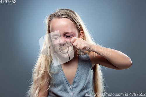 Image of Sad and frightened little girl with bloodshot and bruised eyes, fiction of happiness