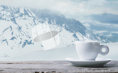 Image of Single tea or coffee mug and landscape of mountains on background