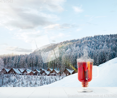 Image of Mulled wine and landscape of mountains on background