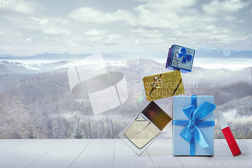 Image of Gifts for family and landscape of mountains on background
