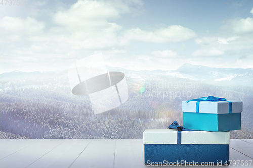 Image of Gifts for family and landscape of mountains on background