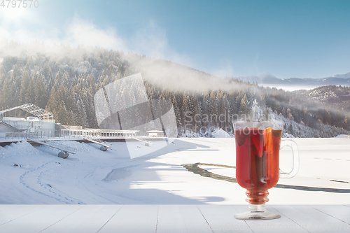 Image of Mulled wine and landscape of mountains on background