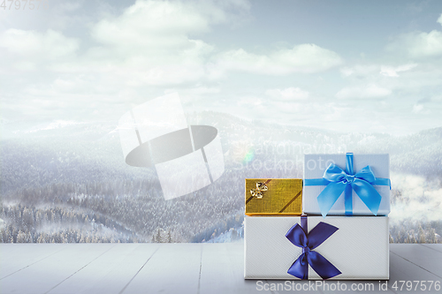 Image of Gifts for family and landscape of mountains on background